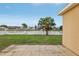 Backyard featuring a lawn, a palm tree, a white fence and a view of a lake at 2726 Herons Landing Dr, Kissimmee, FL 34741