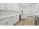 Bright kitchen with stainless steel appliances, quartz counters, and white cabinetry at 2726 Herons Landing Dr, Kissimmee, FL 34741