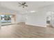 Bright open-concept living room with light-colored wood floors and backyard access at 2726 Herons Landing Dr, Kissimmee, FL 34741