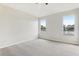 Main bedroom with neutral walls, carpet floors, and large windows overlooking backyard at 2726 Herons Landing Dr, Kissimmee, FL 34741