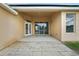 Covered patio area with a concrete floor, overlooking the backyard with sliding glass doors at 2726 Herons Landing Dr, Kissimmee, FL 34741