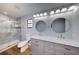 Bathroom features a double vanity, a marble countertop, and tiled shower with glass door at 290 Ne 51St Ave, Ocala, FL 34470