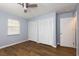 Clean bedroom with wood-look flooring, a window, and two large closets at 290 Ne 51St Ave, Ocala, FL 34470