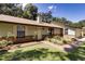 Inviting single-story home features a well-manicured lawn, brick accents, and neutral siding at 290 Ne 51St Ave, Ocala, FL 34470