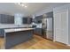 Stylish kitchen features gray cabinets, quartz countertops, island, and stainless steel appliances at 290 Ne 51St Ave, Ocala, FL 34470