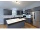 Modern kitchen boasts stainless steel appliances, a central island, and gray cabinetry at 290 Ne 51St Ave, Ocala, FL 34470