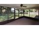 View of the backyard from the screened-in porch with a ceiling fan and easy backyard access at 290 Ne 51St Ave, Ocala, FL 34470