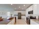 Modern kitchen boasts stainless appliances, white cabinetry, and a large island at 4759 Golden Knight Blvd, Kissimmee, FL 34746