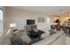 Comfortable living room with a plush sofa, modern decor, and an adjacent dining area at 4759 Golden Knight Blvd, Kissimmee, FL 34746