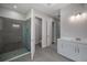 Modern bathroom featuring a glass-enclosed shower, double doors, and a sleek white vanity at 2050 Nw 79Th Loop, Ocala, FL 34475