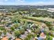 An aerial view showing a verdant community with a neighboring green field at 390 Lisa Karen Cir, Apopka, FL 32712