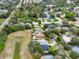 Suburban neighborhood with mature trees, green spaces, and well-maintained homes, as seen from above at 390 Lisa Karen Cir, Apopka, FL 32712