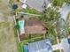 An aerial view of the property showcases its backyard pool, landscaping, and surrounding neighborhood at 390 Lisa Karen Cir, Apopka, FL 32712