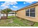 View of the backyard, showing the garden, and a flowering tree climbing up the wooden pergola at 390 Lisa Karen Cir, Apopka, FL 32712