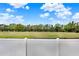 Enjoy serene views from this backyard with a white fence overlooking a picturesque green field at 390 Lisa Karen Cir, Apopka, FL 32712