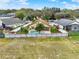 Backyard aerial view featuring a sparkling pool, fenced yard, and manicured landscaping at 390 Lisa Karen Cir, Apopka, FL 32712