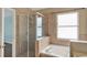 Bright bathroom featuring a glass enclosed shower and soaking tub at 390 Lisa Karen Cir, Apopka, FL 32712