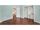 Bedroom featuring wood floors, a closet, and open doorway at 390 Lisa Karen Cir, Apopka, FL 32712