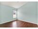 This bedroom features hardwood floors, blue walls, baseboards, and a window with horizontal blinds at 390 Lisa Karen Cir, Apopka, FL 32712