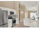 Well-lit kitchen with white cabinets, stainless appliances, an eat-in island, and stone accents at 390 Lisa Karen Cir, Apopka, FL 32712