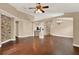 Spacious living room with dark hardwood flooring, stone accent wall, and open layout to the kitchen at 390 Lisa Karen Cir, Apopka, FL 32712