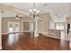 Open-concept living room with hardwood flooring, stone accent, and natural light at 390 Lisa Karen Cir, Apopka, FL 32712