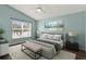 Bright bedroom featuring hardwood flooring, a neutral rug, and many windows at 390 Lisa Karen Cir, Apopka, FL 32712