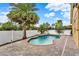 Enjoy the Florida sun by this kidney-shaped pool with brick pavers and a white fence for privacy at 390 Lisa Karen Cir, Apopka, FL 32712