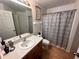 The bathroom features a large vanity, a toilet, and a shower with a patterned curtain at 3079 Barbados Ln, Haines City, FL 33844