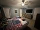 Cozy bedroom offering a television, ceiling fan, and multiple storage options at 3079 Barbados Ln, Haines City, FL 33844