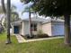 Charming single-story home with well-maintained landscaping and a welcoming blue front door at 3079 Barbados Ln, Haines City, FL 33844