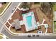 Aerial view of the community pool with lounge seating, tables, and a sun-shade for residents at 5789 Timber Meadow Way, St Cloud, FL 34771