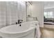 Bathroom featuring a soaking tub, double vanity, and a view into the connected bedroom at 5789 Timber Meadow Way, St Cloud, FL 34771