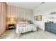 Cozy bedroom with white metal bed frame, striped accent wall, and soft pink accents at 5789 Timber Meadow Way, St Cloud, FL 34771