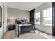 Neutral bedroom with a wrought iron bed frame, modern lamps, and a view through two windows at 5789 Timber Meadow Way, St Cloud, FL 34771