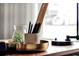 A close-up of desk accessories, featuring a pen holder and a decorative tray, on a wooden desk at 5789 Timber Meadow Way, St Cloud, FL 34771