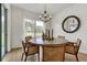 Dining area with wood table, chairs and a round decorative mirror at 5789 Timber Meadow Way, St Cloud, FL 34771