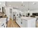 Bright kitchen with stainless steel appliances, white cabinets, and large island with pendant lighting at 5789 Timber Meadow Way, St Cloud, FL 34771