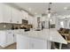 Beautiful kitchen with a large white quartz island, stainless steel appliances, and stylish pendant lighting at 5789 Timber Meadow Way, St Cloud, FL 34771