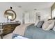 Well-decorated main bedroom with a dresser, a round mirror and connecting doorways at 5789 Timber Meadow Way, St Cloud, FL 34771