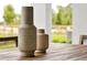 Two stone vases on a wooden outdoor table, with greenery visible in the background at 5789 Timber Meadow Way, St Cloud, FL 34771