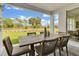 Outdoor covered patio featuring a wood table with seating, a patterned rug, and a view of the backyard at 5789 Timber Meadow Way, St Cloud, FL 34771