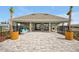 Community pool cabana featuring a covered seating area with stone accents and trash receptacles at 5789 Timber Meadow Way, St Cloud, FL 34771