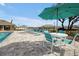 Poolside seating area features turquoise chairs, tables, and umbrellas for relaxation at 5789 Timber Meadow Way, St Cloud, FL 34771