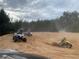 ATV riders racing across sandy dunes, depicting recreational opportunities and the property's adventurous potential at 24645 Ne 177Th Ter, Fort Mc Coy, FL 32134