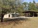 Exterior view with covered picnic shelter, lush green trees, and natural setting at 24645 Ne 177Th Ter, Fort Mc Coy, FL 32134