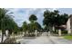 Community gated entrance with mature trees and landscaping at 3106 S Semoran Blvd # 5, Orlando, FL 32822