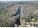 Expansive aerial view of a waterway winding through lush, green forest, showing the property's secluded location at 9461 Cr 657, Bushnell, FL 33513