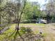 Expansive backyard with fenced area, mature trees, and access to the water with boat dock at 9461 Cr 657, Bushnell, FL 33513