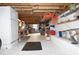 Spacious basement with exposed wooden ceiling beams, workbench, shelves and abundant storage options at 9461 Cr 657, Bushnell, FL 33513